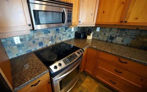 Kitchen range, microwave and tile backsplash