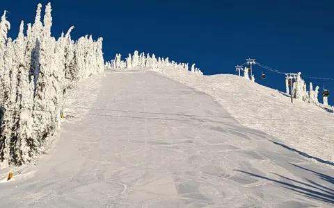 Freshly groomed run through snow ghosts